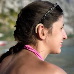 Woman wearing hearing aids at the beach